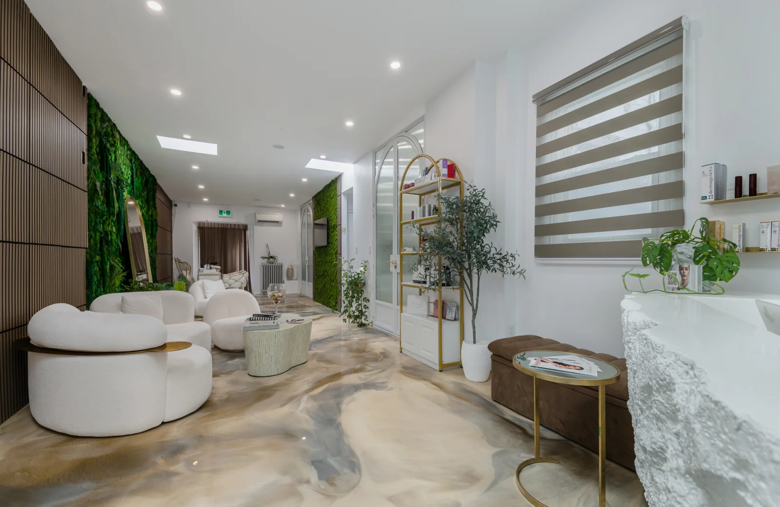 The Activate Beauty studio in Bloor West Village, Toronto — marble floor, signature moss wall and bouclé lounge